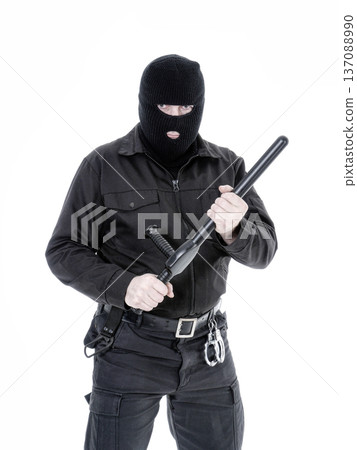 Antiterrorist policeman in black uniform and black balaclava Antiterrorist policeman in black uniform and black balaclava 137088990