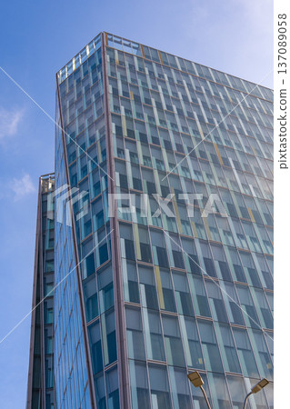 Building towers under blue sky in a city landscape with clear visibility and modern architecture during daylight hours Building towers under blue sky in a city landscape with clear visibility and modern architecture during daylight hours 137089058