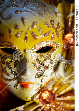 A close view of a painted mask reveals detailed art and bright colors. The mask has intricate designs and stands out against a simple background. A close view of a painted mask reveals detailed art and bright colors. The mask has intricate designs and stands out against a simple background. 137089118