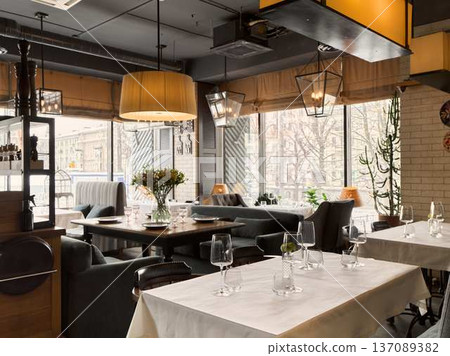 Sunlit modern bistro interior intimate urban lunch setting Sunlit modern bistro interior intimate urban lunch setting 137089382