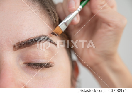 Caucasian woman getting eyebrow tinting procedure.  137089541