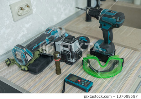 Construction tools on the kitchen floor.  137089587