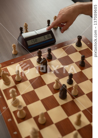 Close up of hands of middle aged caucasian man playing chess. Close up of hands of middle aged caucasian man playing chess. 137089605