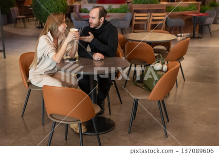 A Caucasian couple on a date in a cafe.  137089606