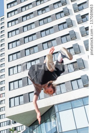 A girl jumps on an outdoor trampoline. A girl jumps on an outdoor trampoline. 137089663