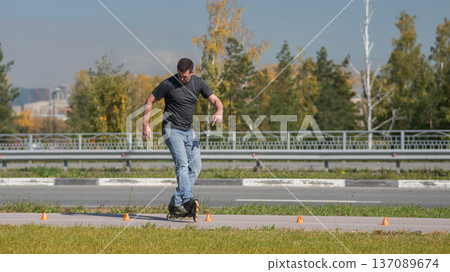 A Caucasian man rollerblades around the slalom course. 137089674