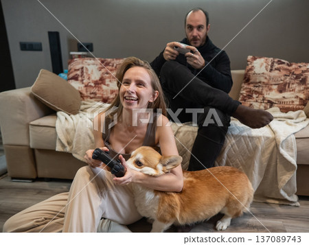 A Caucasian couple playing a video game console. A Caucasian couple playing a video game console. 137089743