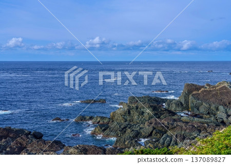 A view of a fishing boat sailing across the vast ocean and steep cliffs seen from Cape Shionomisaki A view of a fishing boat sailing across the vast ocean and steep cliffs seen from Cape Shionomisaki 137089827