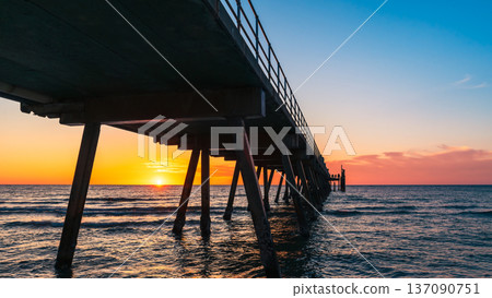 Glenelg jetty silhouette at sunset with warm evening colours Glenelg jetty silhouette at sunset with warm evening colours 137090751