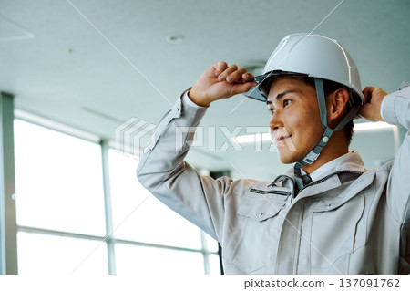 Workers wearing helmets Workers wearing helmets 137091762