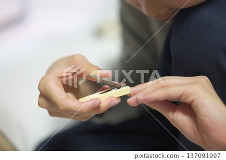 Child's hands cutting nails Child's hands cutting nails 137091997