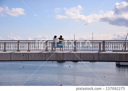 Two women taking a commemorative photo on the bridge at Atami Sky Deck Two women taking a commemorative photo on the bridge at Atami Sky Deck 137092275