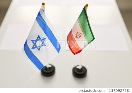 Israel and Iran flags on negotiation table, symbol of meeting diplomacy today 137092758