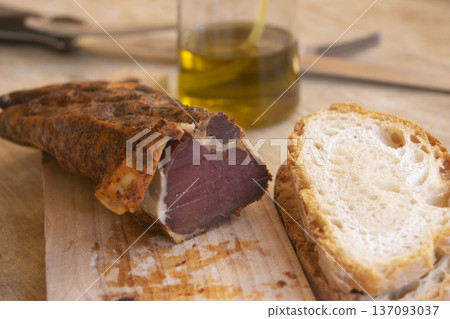 Traditional dried meat with bread and olive oi 137093037