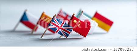 Small national flags of china, uk, czech republic, spain, japan, and other countries are standing on a white table, representing international relations, global business, or political alliances 137093253