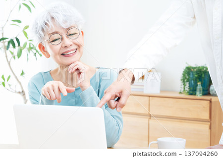Senior woman being taught how to use a computer Senior woman being taught how to use a computer 137094260