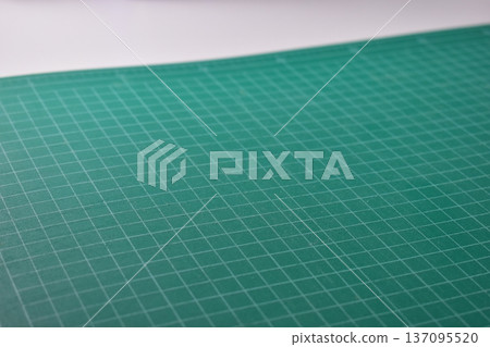 green cutting mat board on white background with line and scale measure guide pattern for art design green cutting mat board on white background with line and scale measure guide pattern for art design 137095520
