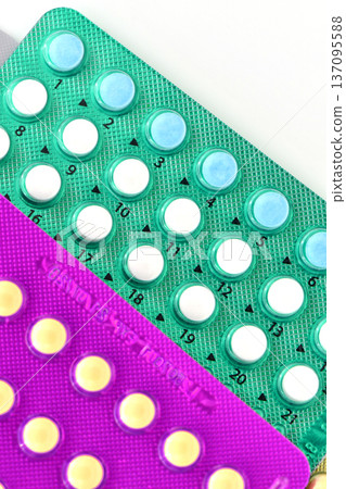 Collection of hormonal birth control pills in different colors and packaging. Collection of hormonal birth control pills in different colors and packaging. 137095588