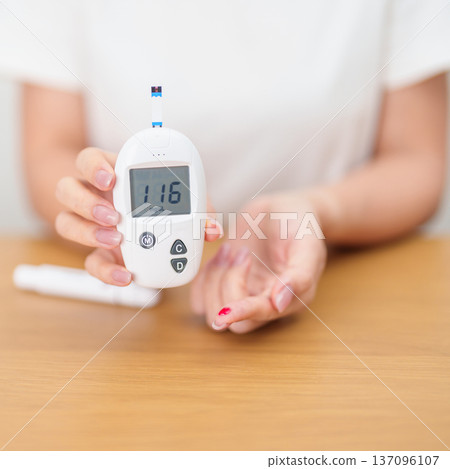 Hand checking Diabetes or Blood glucose self testing by digital blood glucose meter with lancet pen. high blood sugar level, World Diabetes Day, Glycemia, Hypoglycemia, Hyperglycemia and insulin Hand checking Diabetes or Blood glucose self testing by digital blood glucose meter with lancet pen. high blood sugar level, World Diabetes Day, Glycemia, Hypoglycemia, Hyperglycemia and insulin 137096107