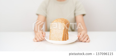 Happy smiling woman with whole wheat bread. Weight loss management, Dieting, Healthy eating, Calorie control, Fitness food, High fiber, Wellness, Lifestyle, Metabolism and Glycemic Index Happy smiling woman with whole wheat bread. Weight loss management, Dieting, Healthy eating, Calorie control, Fitness food, High fiber, Wellness, Lifestyle, Metabolism and Glycemic Index 137096115