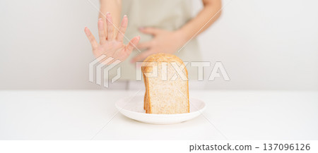 Gluten intolerance, Gluten free and celiac disease or Wheat allergy. woman with wheat bread and having abdominal pain after eat gluten. stomach ache, Nausea, Bloating, Gas, Diarrhea and Skin rash Gluten intolerance, Gluten free and celiac disease or Wheat allergy. woman with wheat bread and having abdominal pain after eat gluten. stomach ache, Nausea, Bloating, Gas, Diarrhea and Skin rash 137096126