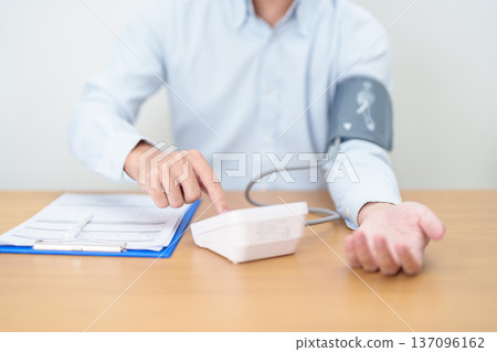 Man checking Blood pressure by Blood pressure monitor with Cuff. Systolic, SYS, Diastolic, DIA, Pulse, Hypertension, Hypotension, Heart rate, Cardiovascular Disease and May World hypertension day Man checking Blood pressure by Blood pressure monitor with Cuff. Systolic, SYS, Diastolic, DIA, Pulse, Hypertension, Hypotension, Heart rate, Cardiovascular Disease and May World hypertension day 137096162