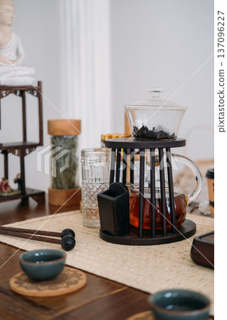 Chinese tea ceremony. Healthy herbal drink. Transparent brew water tasty liquid clear cup glass teapot for calming fresh beverage. Chinese tea ceremony. Healthy herbal drink. Transparent brew water tasty liquid clear cup glass teapot for calming fresh beverage. 137096227