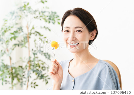 Woman eating persimmon Food image Woman eating persimmon Food image 137096450