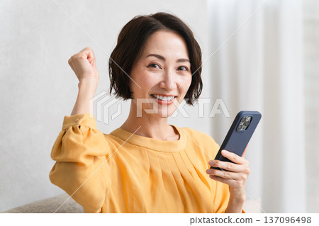 Woman operating a smartphone Lifestyle image Woman operating a smartphone Lifestyle image 137096498