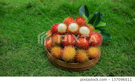 A pile of rambutan fruit with white flesh on basket, organic tropical fruit  137096811