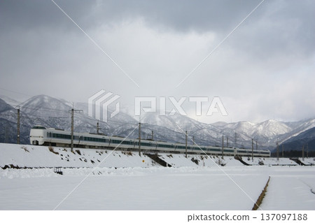 Express train 683 series running through snowy fields 137097188
