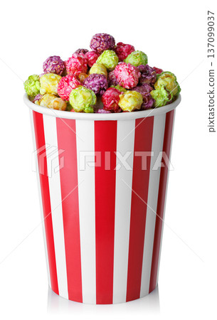 Caramelized fruit popcorn in red and white striped paper bucket isolated on white Caramelized fruit popcorn in red and white striped paper bucket isolated on white 137099037