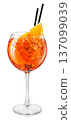 Cold aperol spritz cocktail in glass with straw and slice of orange isolated on white background 137099039