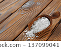 Sea salt in scoop on brown wooden table 137099041