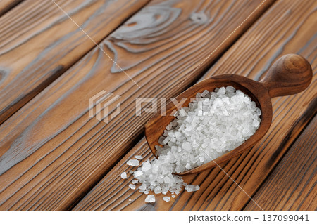Sea salt in scoop on brown wooden table 137099041