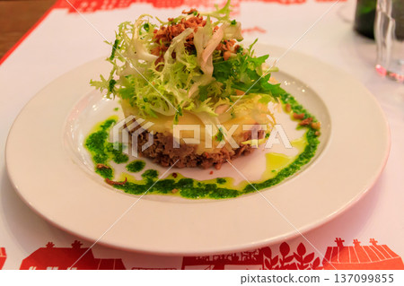 Duck confit with mashed potatoes and salad on a table in restaurant Duck confit with mashed potatoes and salad on a table in restaurant 137099855