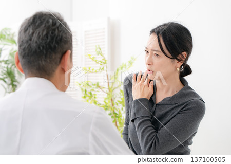 Woman unable to lift arm - Frozen shoulder 137100505
