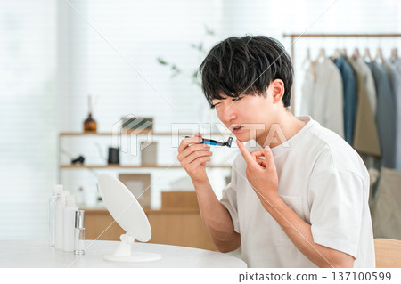 一名男子刮鬍子時皮膚灼痛(敏感肌膚,刮鬍子) 一名男子刮鬍子時皮膚灼痛(敏感肌膚,刮鬍子) 137100599