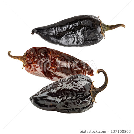 Dried chili peppers scattered and isolated on white background, spicy food concept, showcasing culinary ingredients texture Dried chili peppers scattered and isolated on white background, spicy food concept, showcasing culinary ingredients texture 137100803