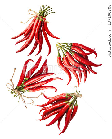 Bunches of red chili peppers with green leaves isolated  on white background, concept of spice and flavor 137100806