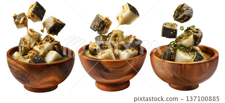 Steamed taro and rice cakes with coconut sauce, scallions, and peanuts in wooden bowl, isolated on white background 137100885