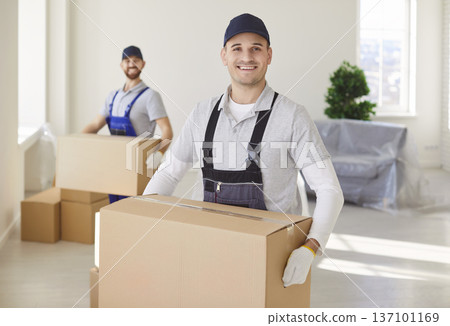 Portrait Of Happy Mover With Box During Move Portrait Of Happy Mover With Box During Move 137101169