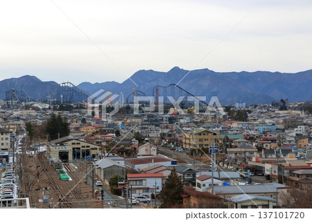 View of Fuji Q Highland park from the roof of the Fujisan, Mt. Fuji, train station of Yamanakako in Yamanashi Japan during an overcast winter day 137101720