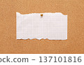 A blank paper sheet for writing is attached to a cork board. 137101816