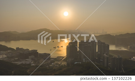 Glowing Sunset Spreads Warm Light Across Junk Bay Feb 22 2026 137102226