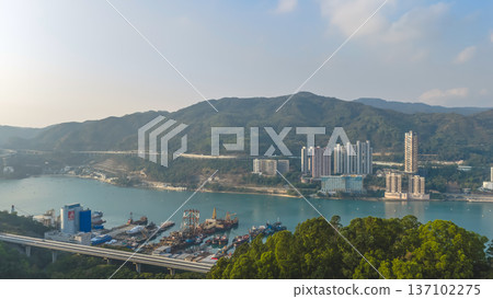 Scenic Hillside Coastline Blending Industry, Housing, And Natural Landscape Feb 21 2026 137102275