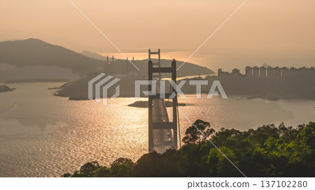 Iconic Suspension Bridge Illuminated At Sunset Over Tranquil Waters Feb 21 2026 137102280