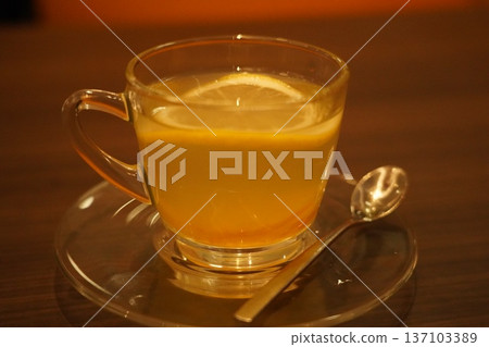 Warm Lemon Ginger Drink in Glass Cozy Citrus Infusion Warm Lemon Ginger Drink in Glass Cozy Citrus Infusion 137103389