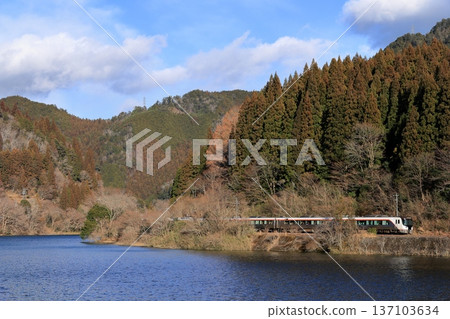 Hida Express train running along the Hida River in winter Hida Express train running along the Hida River in winter 137103634