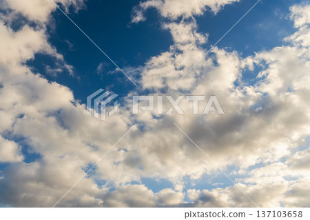 Winter evening blue sky and sparkling fluffy white clouds 39 137103658